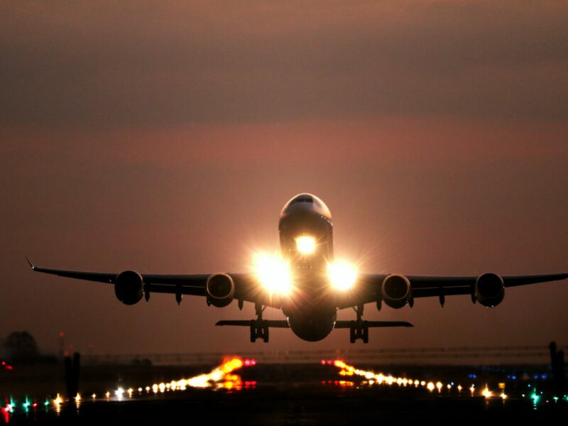 A plane takes off at sunset