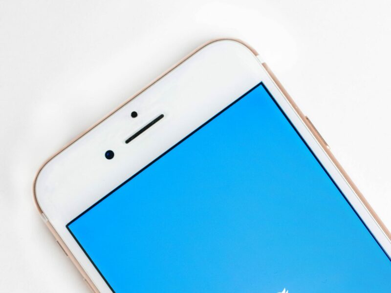 A white iPhone with Twitter on the screen