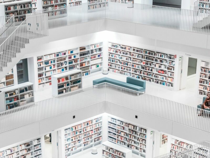 The interior shelves of a dreamy multi-storied white library complex